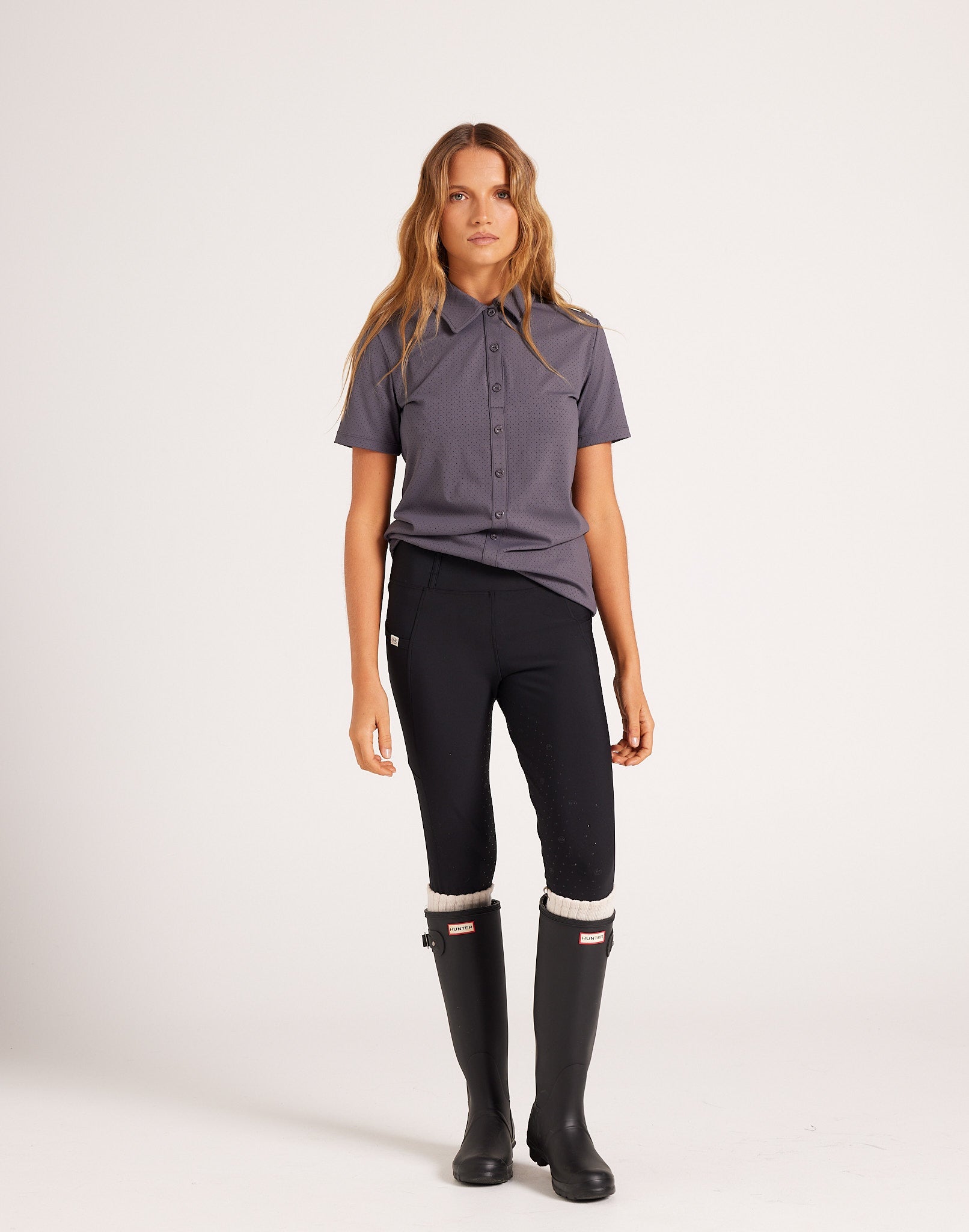Women's high-rise knee grip black equestrian breeches for horse riding, designed with performance stretch fabric, supportive waistband, flattering seam lines, and functional pockets. Versatile riding pants for schooling, casual rides, barn days, and everyday equestrian wear.