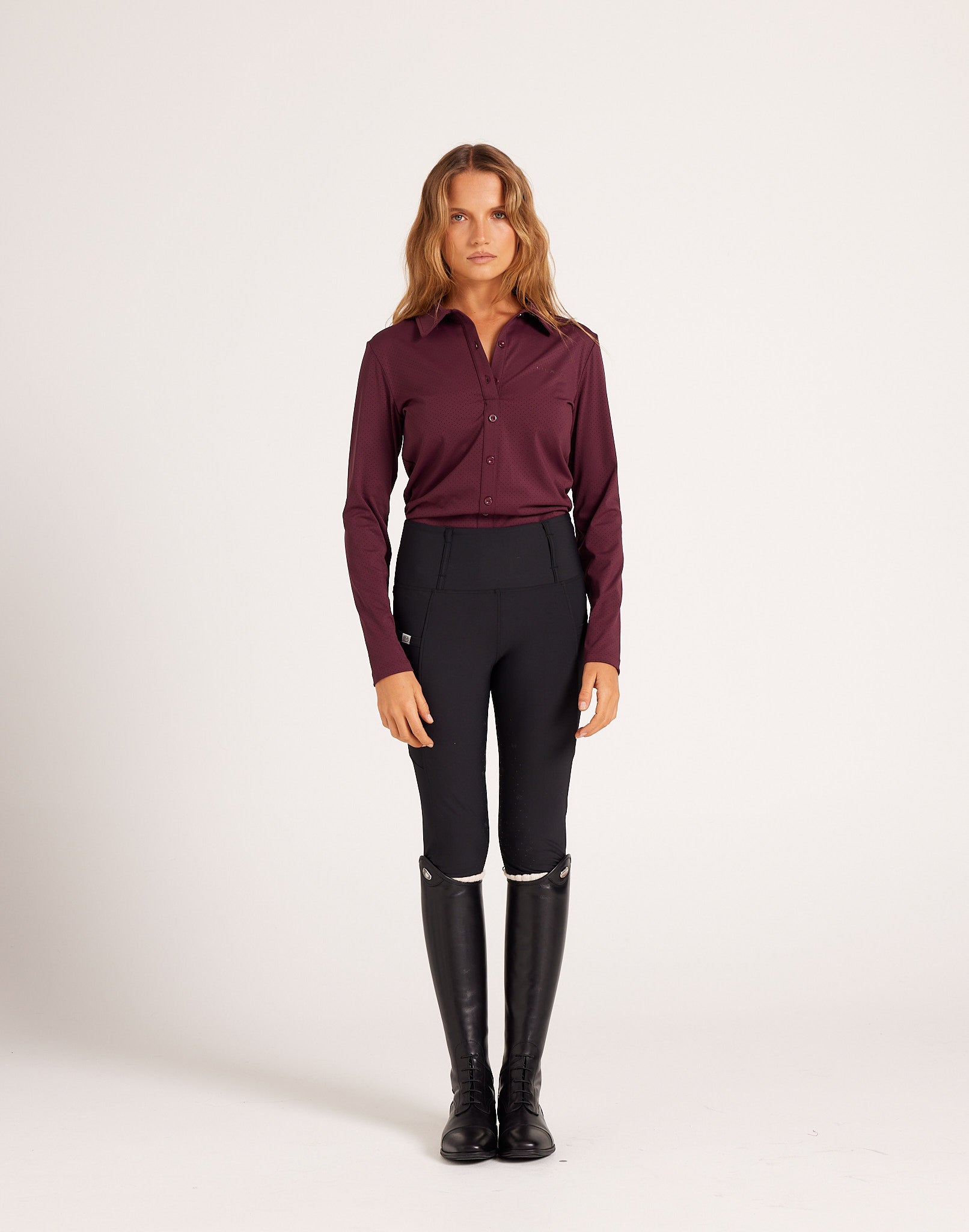 Women's high-rise knee grip black equestrian breeches for horse riding, designed with performance stretch fabric, supportive waistband, flattering seam lines, and functional pockets. Versatile riding pants for schooling, casual rides, barn days, and everyday equestrian wear.